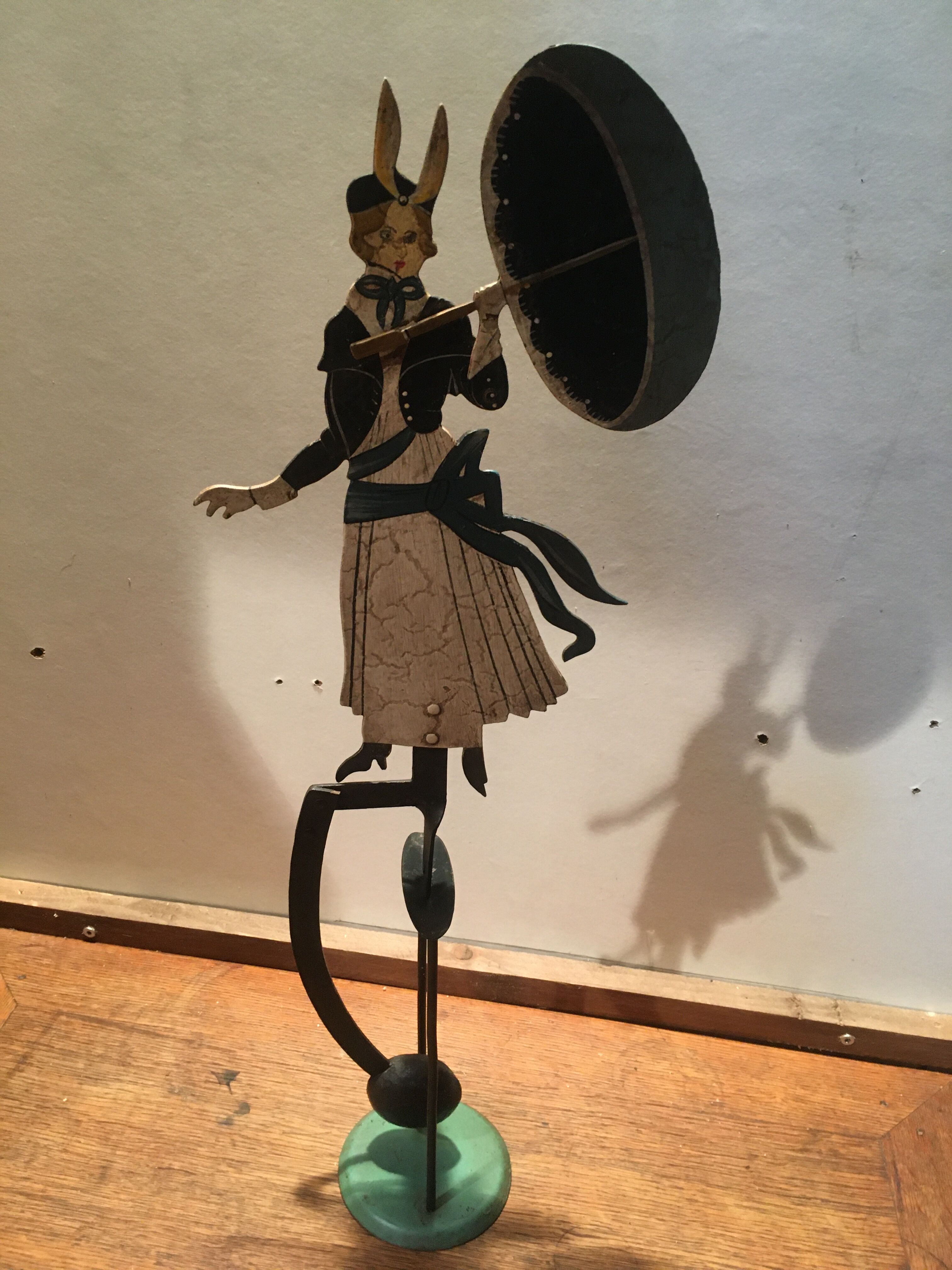 Woman with metal umbrella, pendulum
