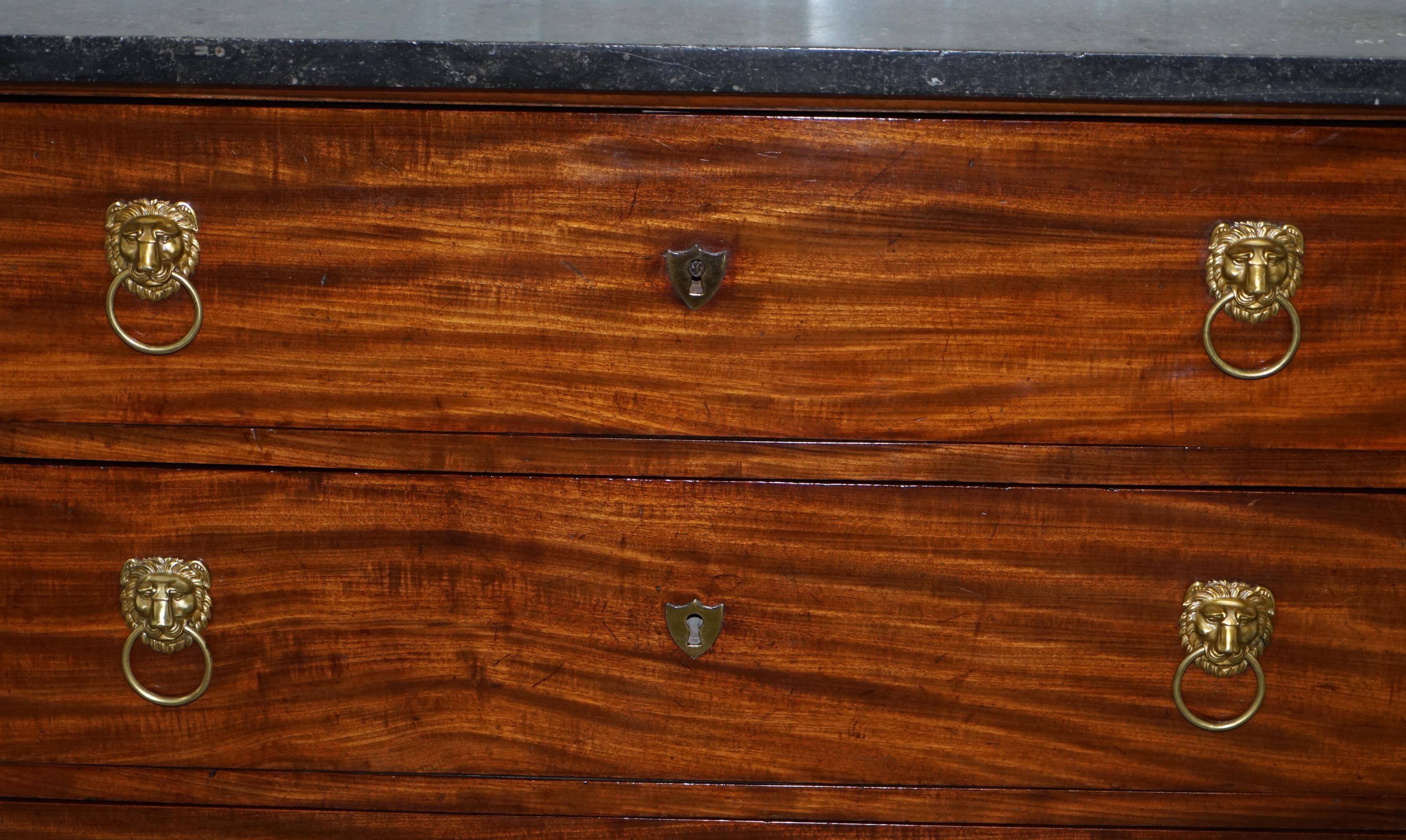 19th-century Empire commode with a marble top and lion paw feet.