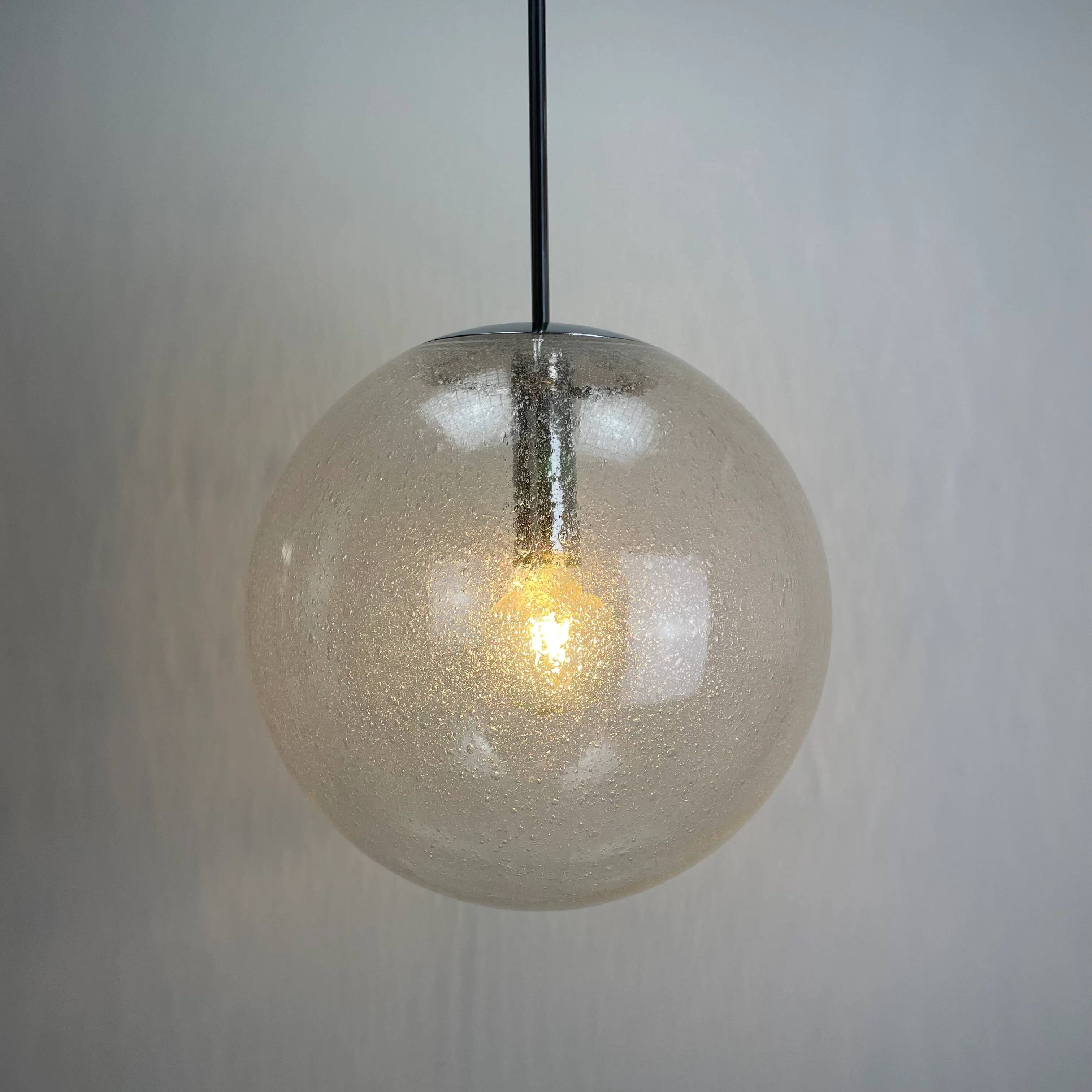 Large suspended lamp with a glass globe featuring bubbles by Peill & Putzler 1970.