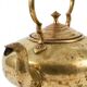 Victorian tripod kettle made of brass with a porcelain handle.