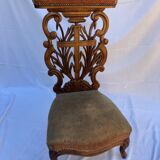 Low armchair in carved wood