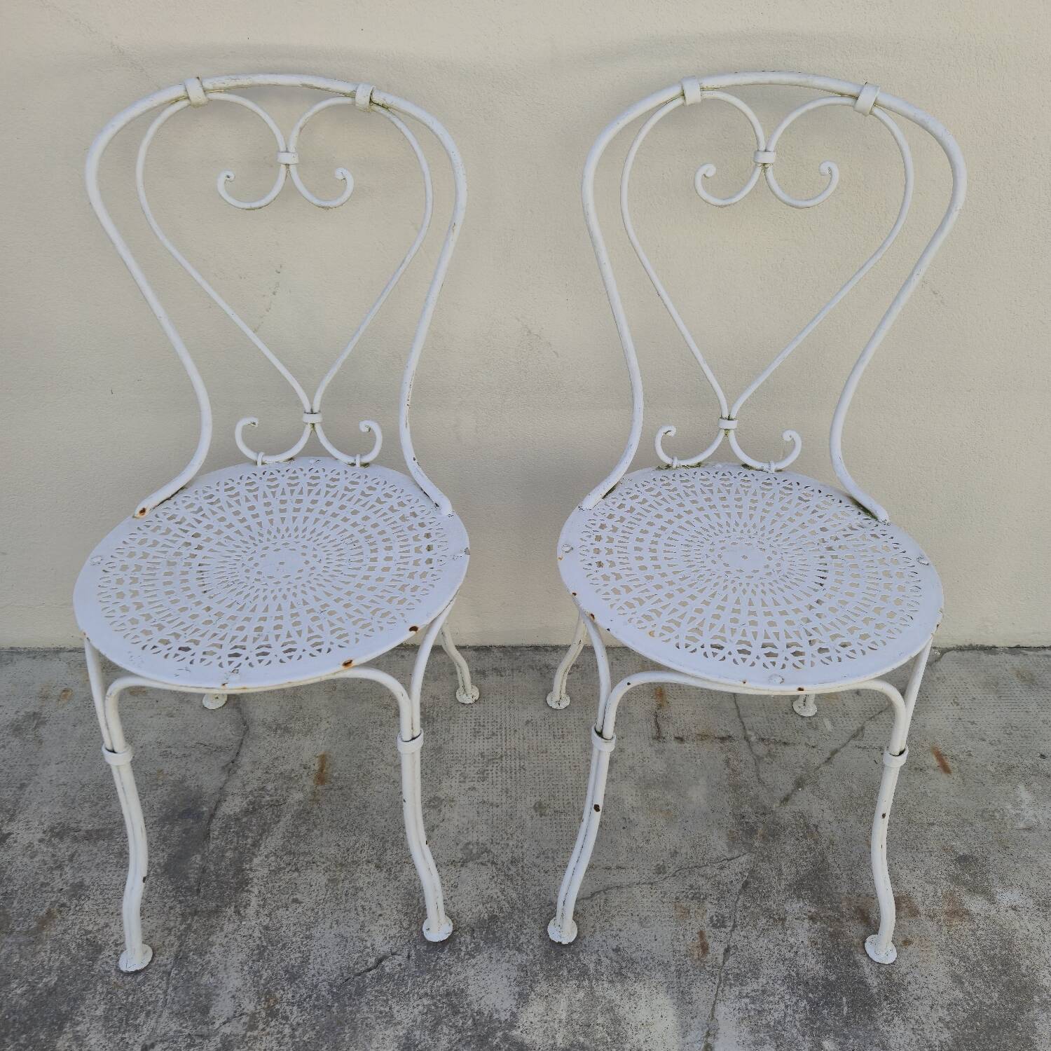 Pair of wrought iron garden chairs, antique manufacture