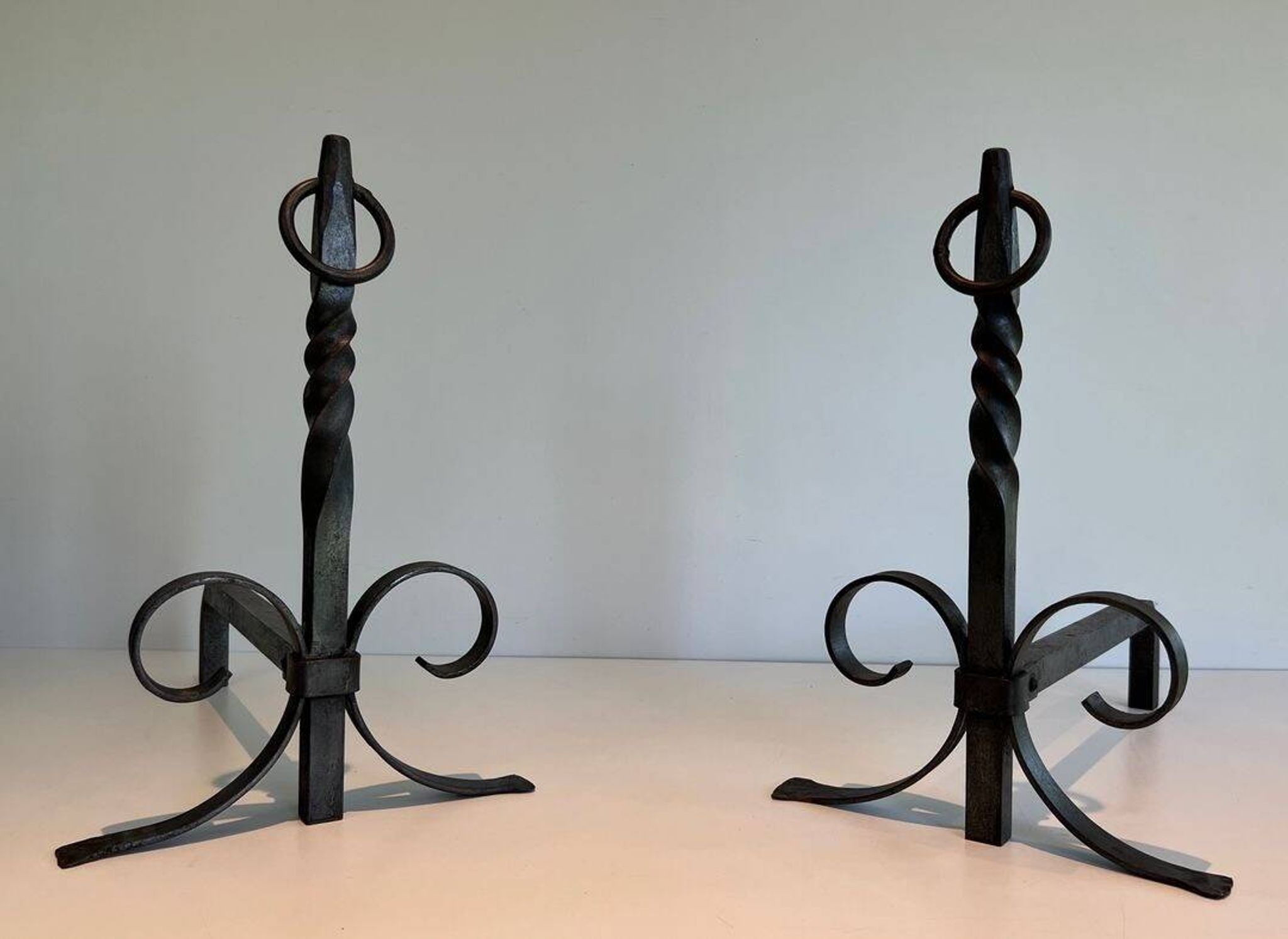 Pair of Neoclassical Fire Dogs in Wrought Iron with Twisted Columns, Finials