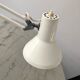 Off-white articulated architect lamp.