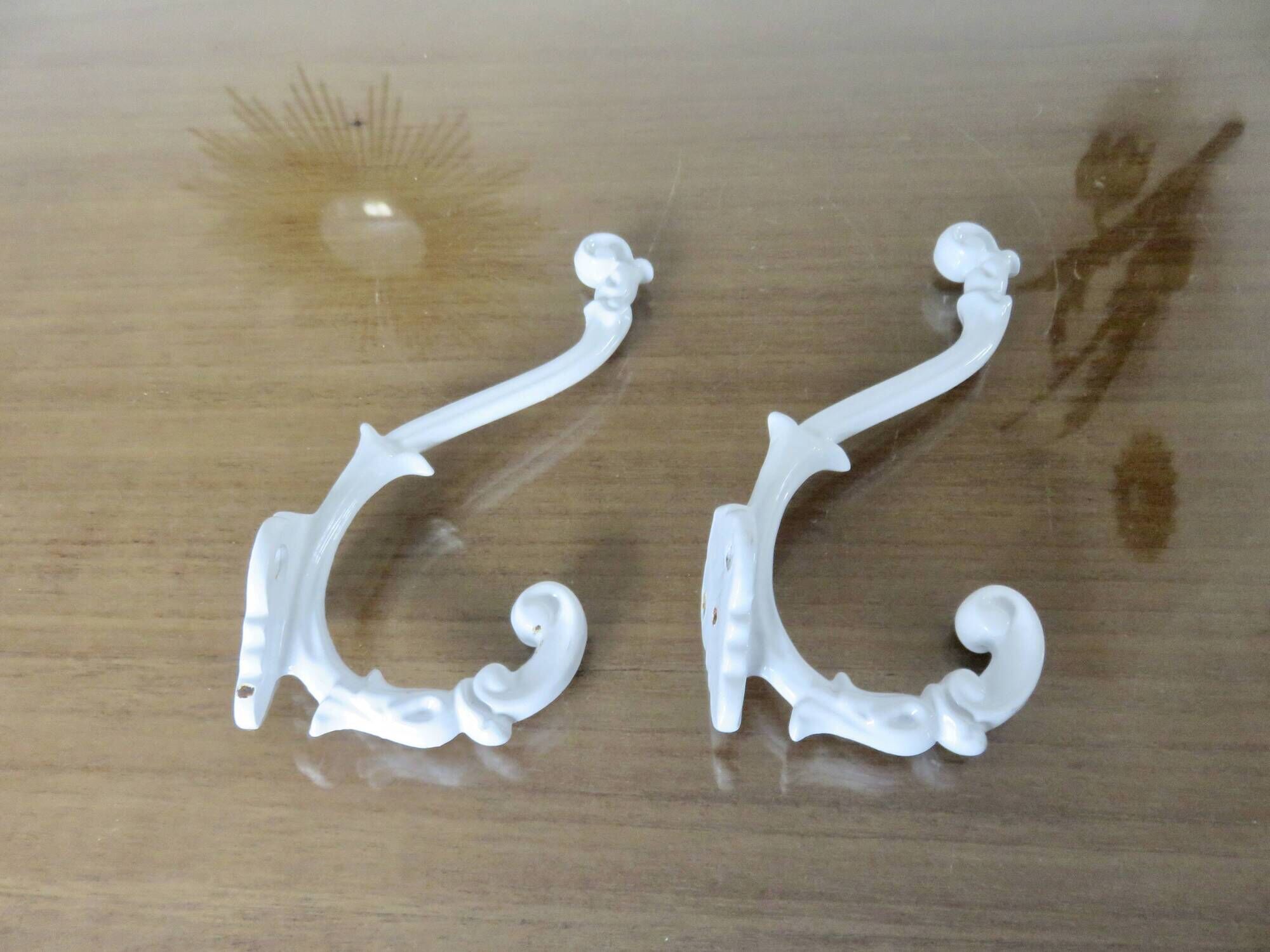 Pair of Art Deco white cast iron coat hooks from the 1930s and 1940s