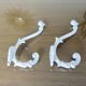 Pair of Art Deco white cast iron coat hooks from the 1930s and 1940s