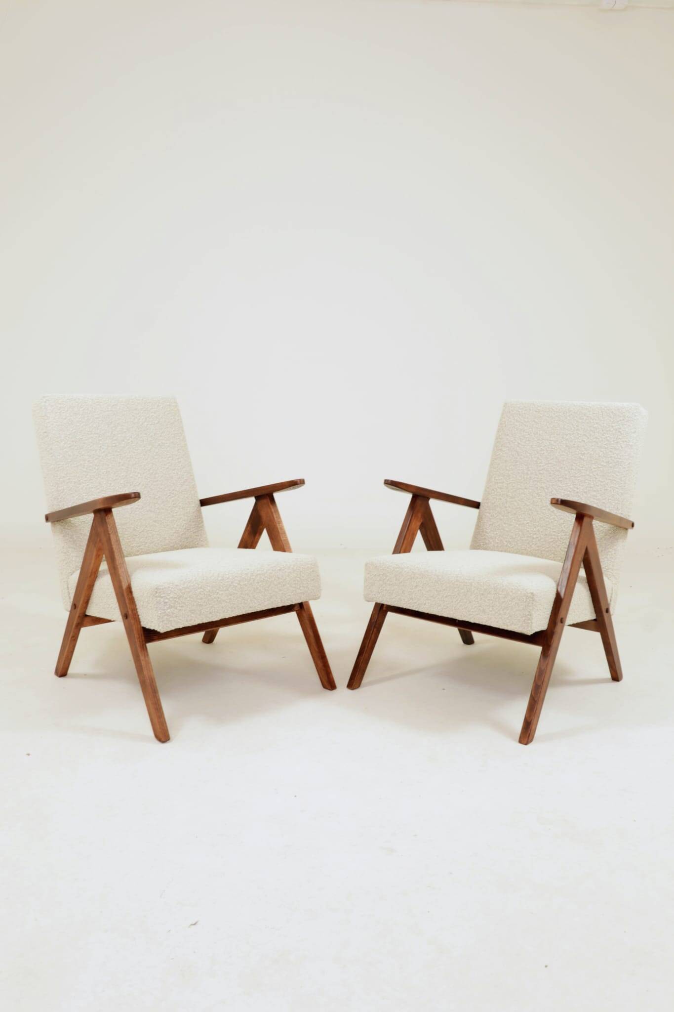 Pair of Mid-Century Modern armchairs in solid beech and boucle fabric.