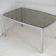 Living table. chrome metal, curved smoked glass slab, france, circa 1970.