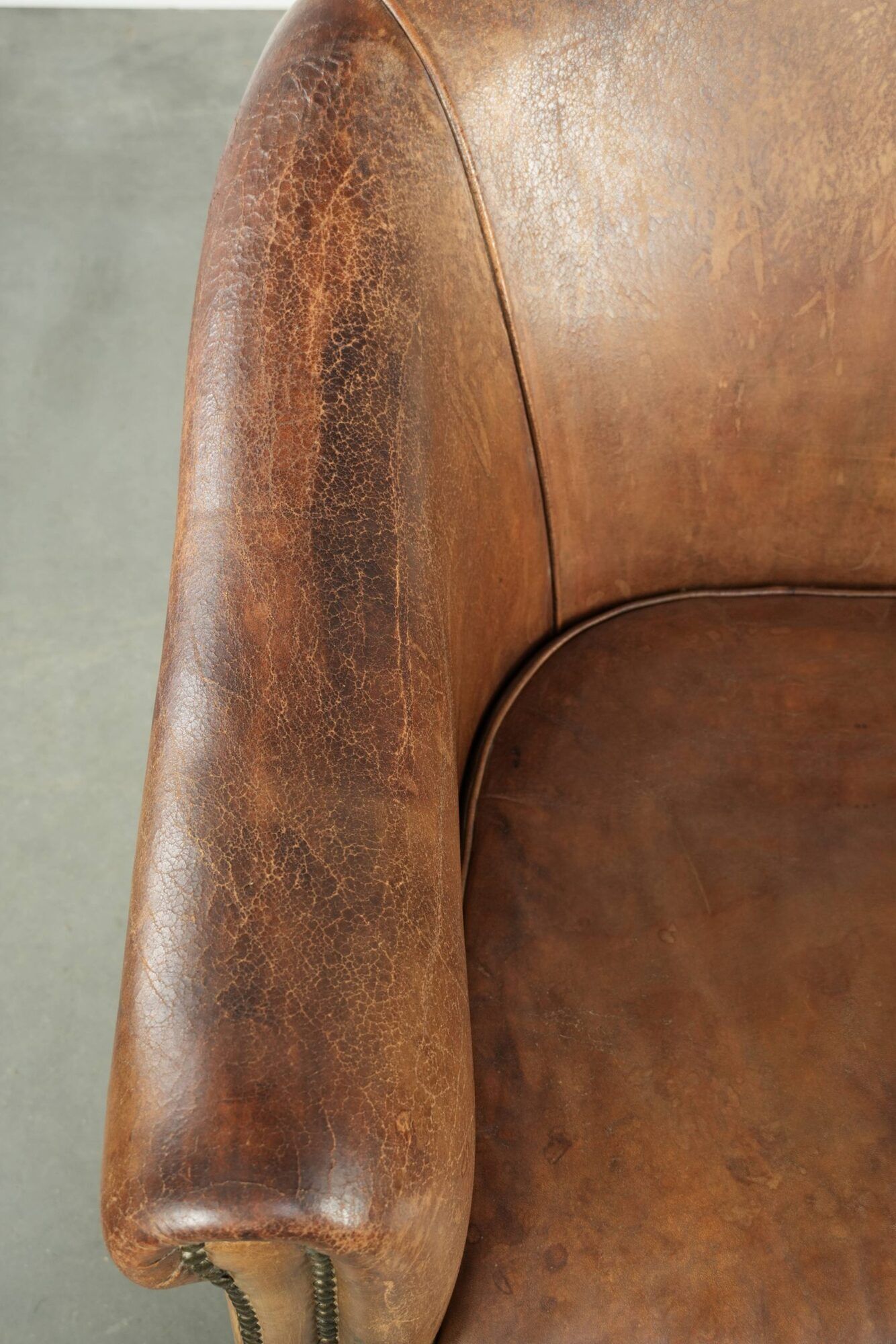 Vintage sheepskin club armchair finished with decorative nails