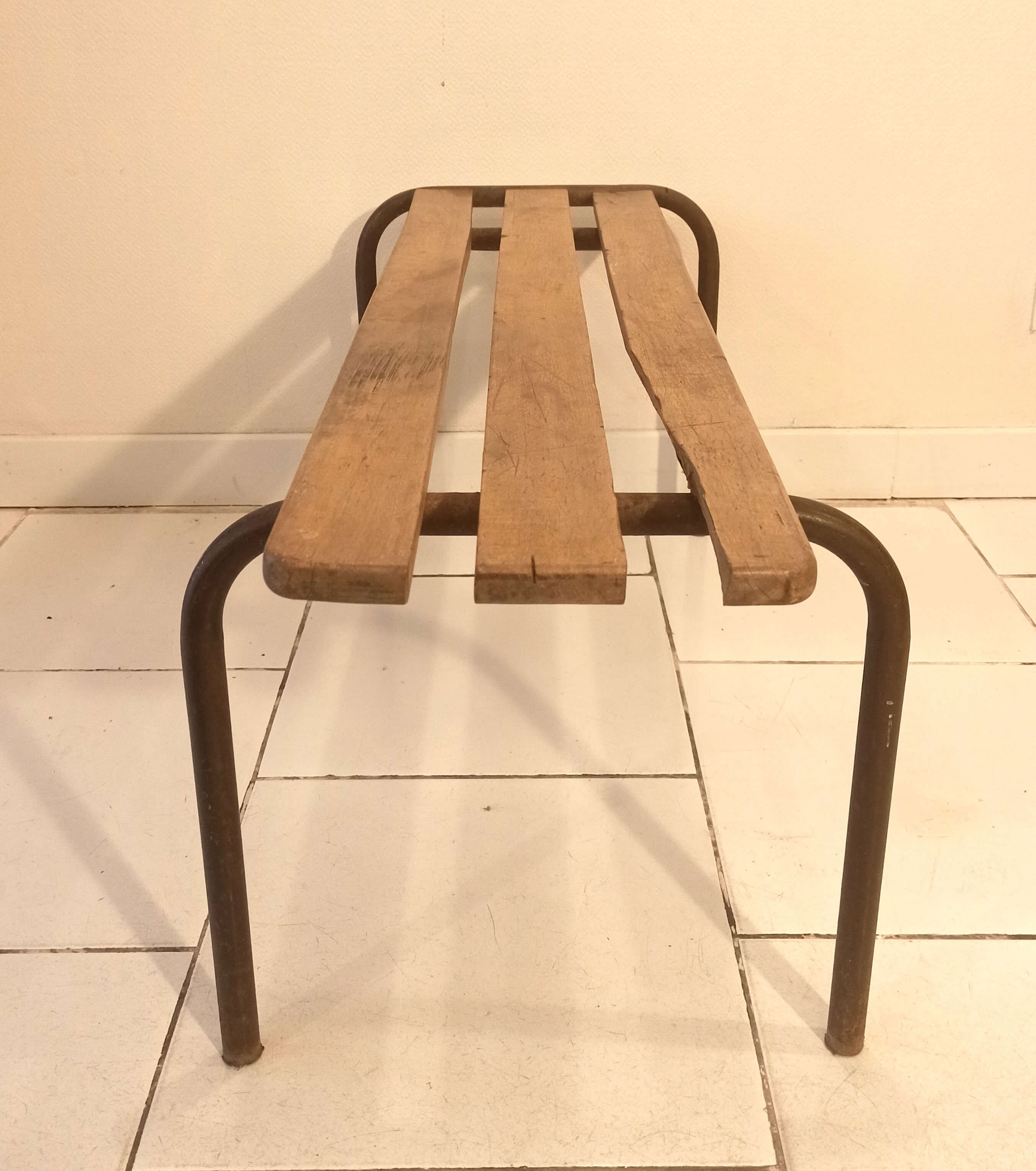 Old bench wooden slats and tubular metal base