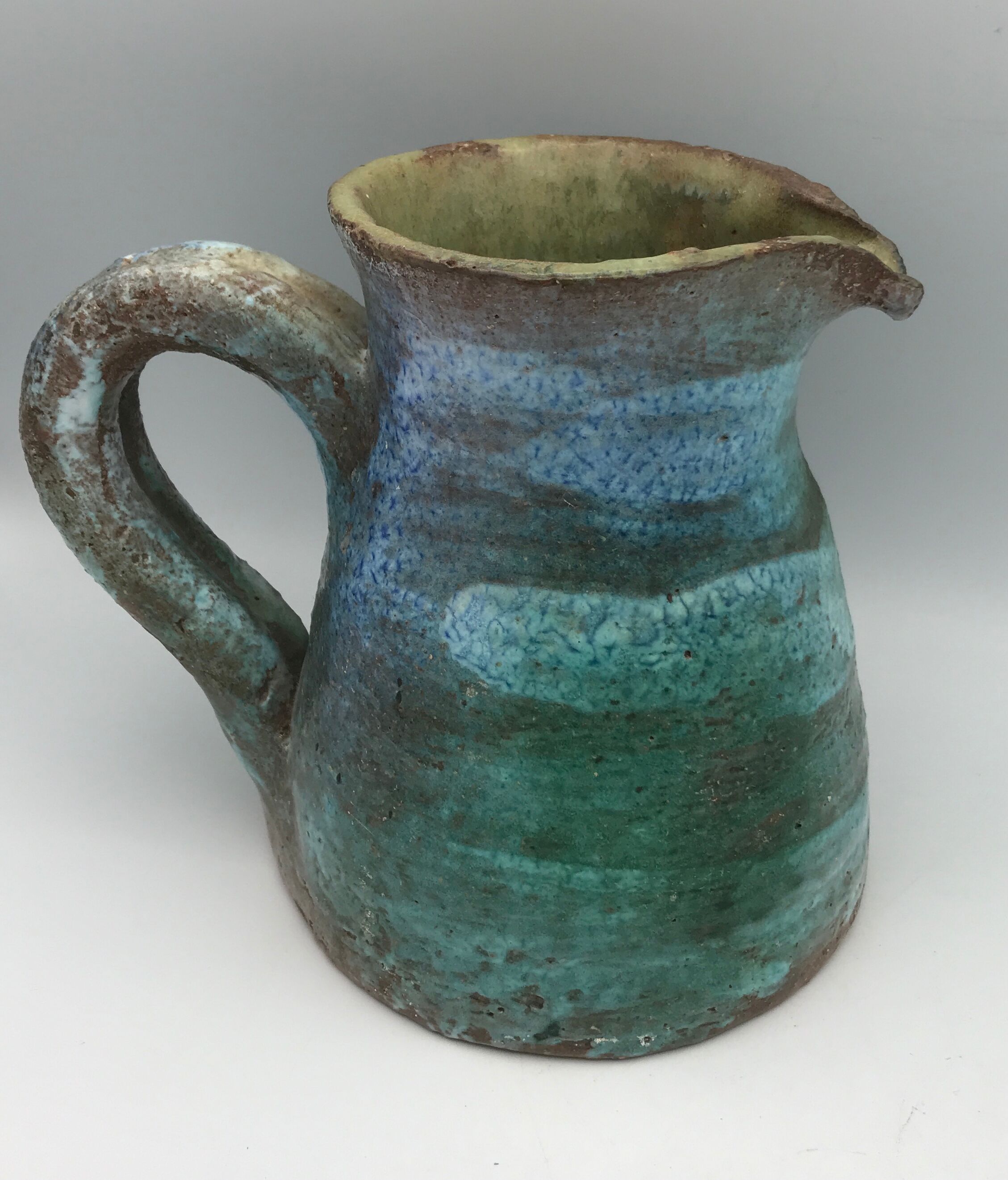 Vintage broc pitcher in enamelled sandstone with effect of blue shades, turquoise green signed