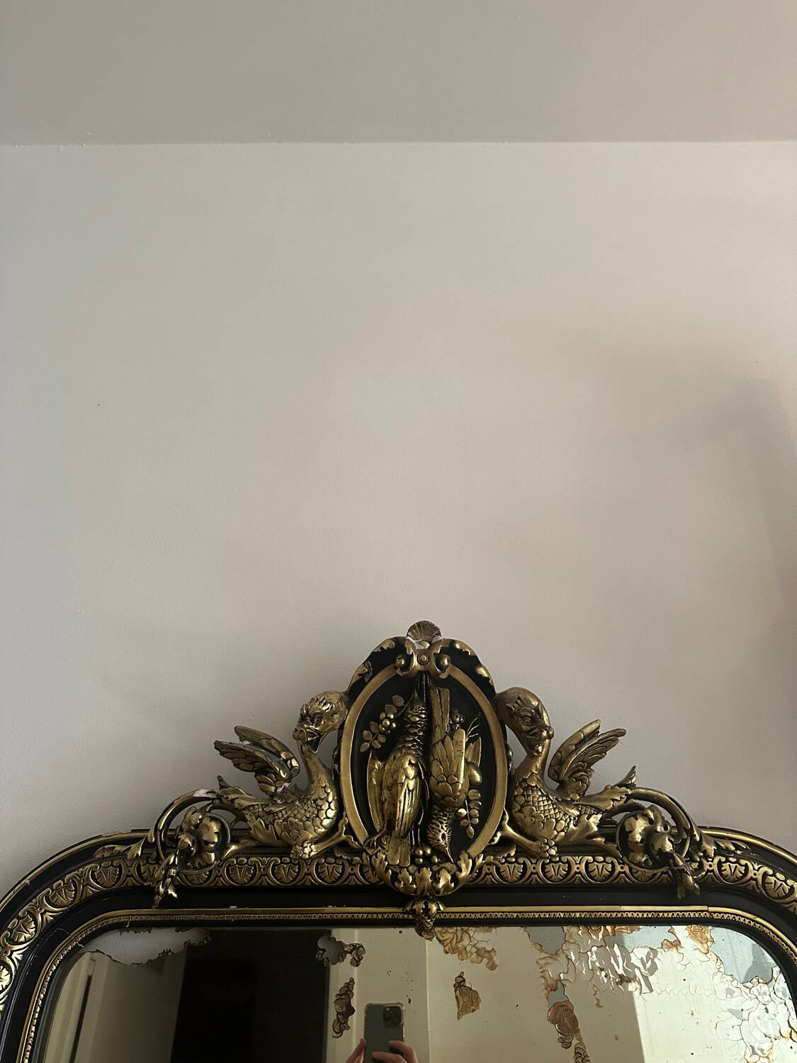 Napoleon III mirror with a pediment featuring black and gold dragons and birds.
