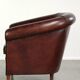 Vintage sheepskin club armchair with decorative nails and black piping