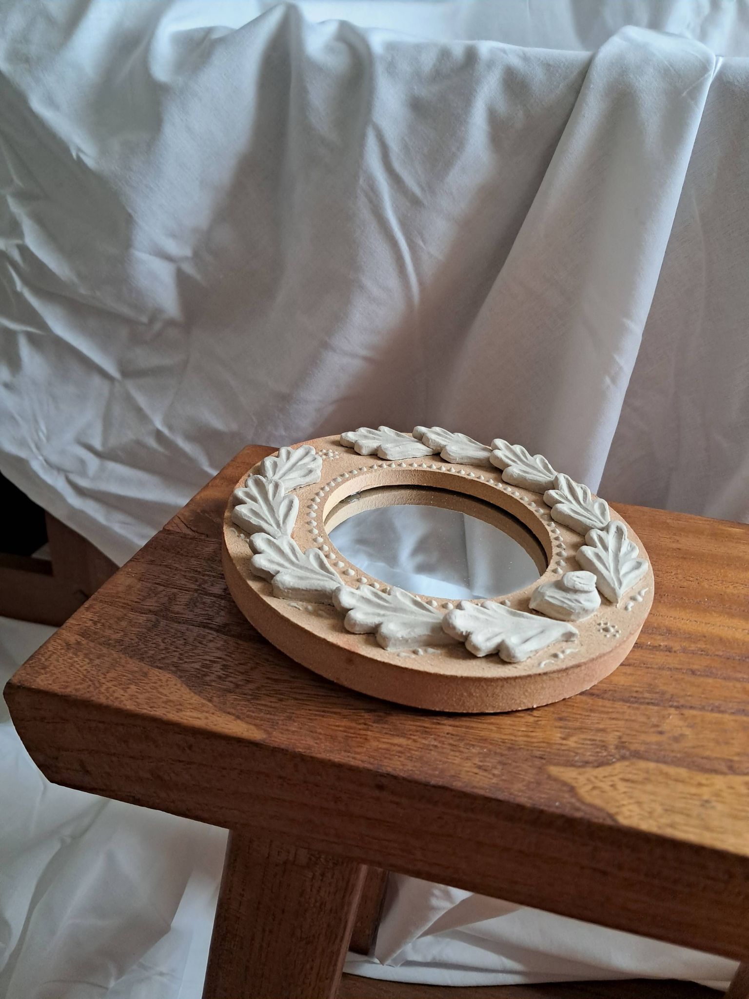 Red and white stoneware mirror, oak leaves