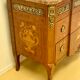 Transition chest of drawers with floral marquetry and music trophy