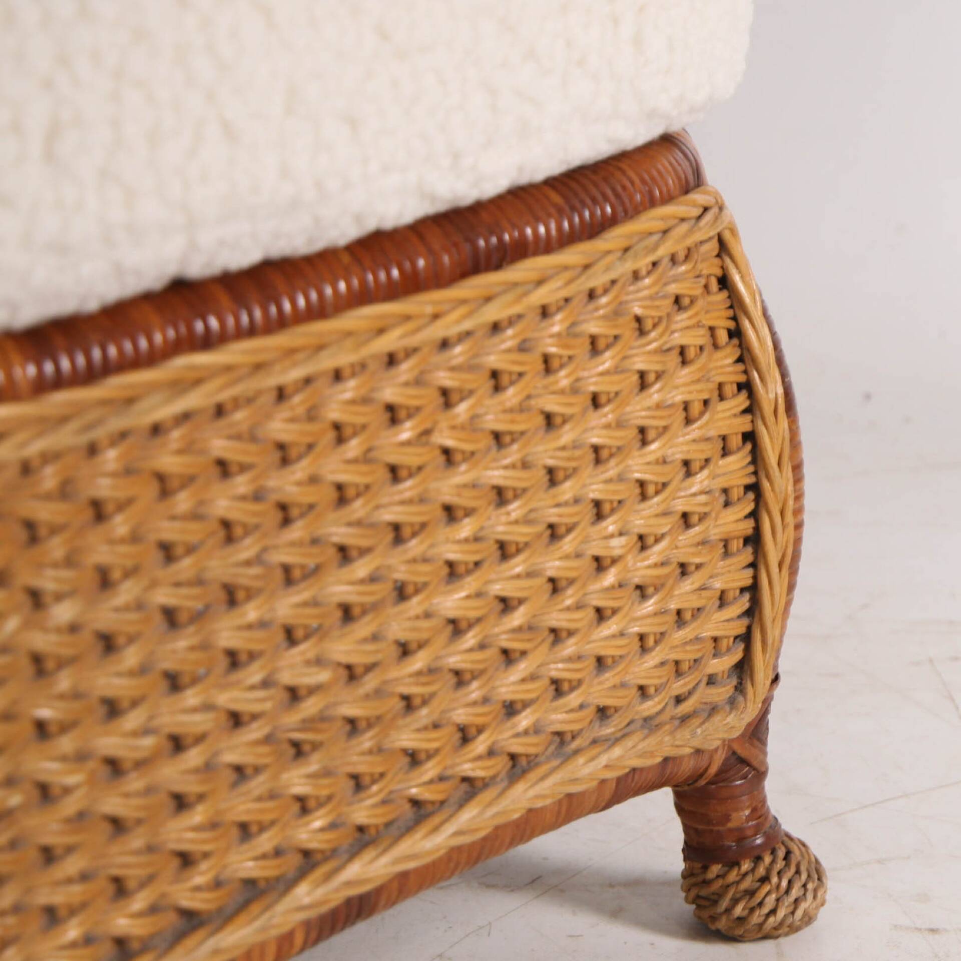 Large wicker armchair and its ottoman