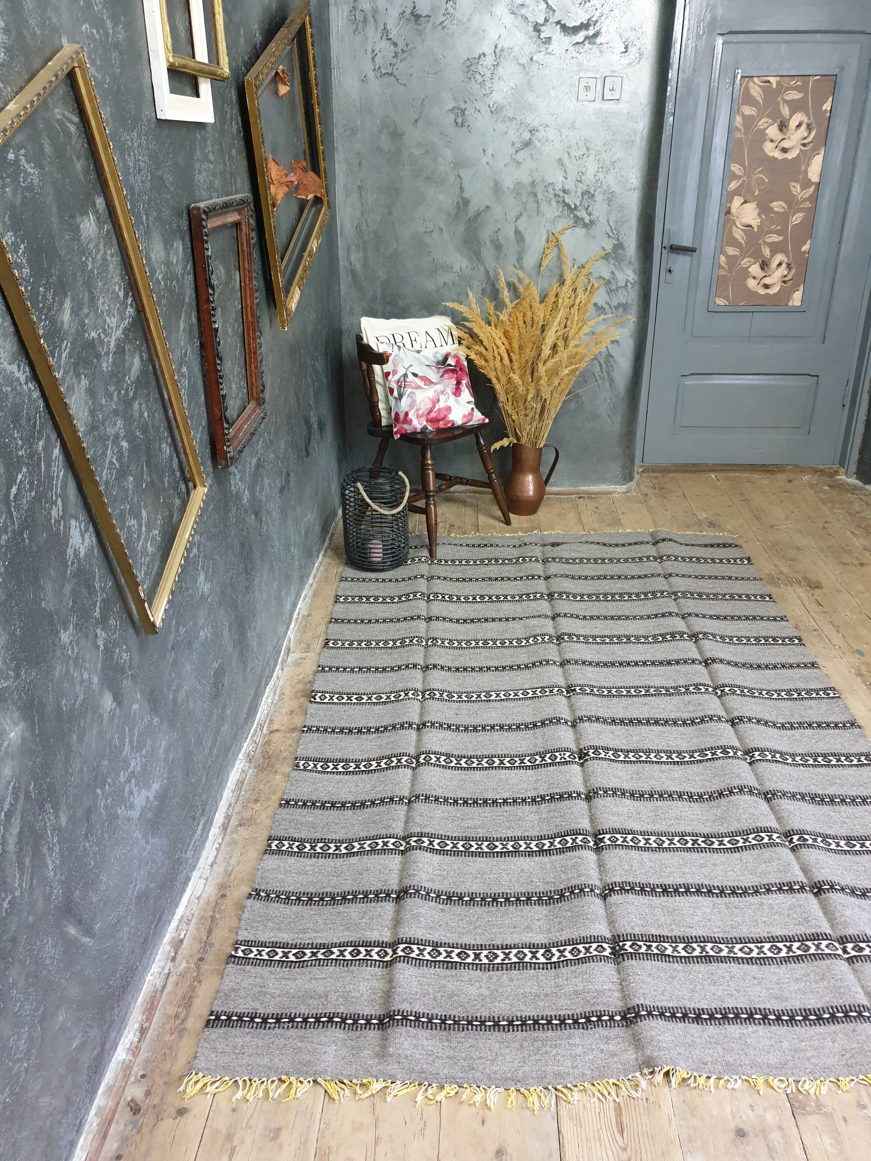 Handwoven vintage geometrical rug, grey background