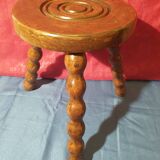 Wooden milking stool with twisted legs
