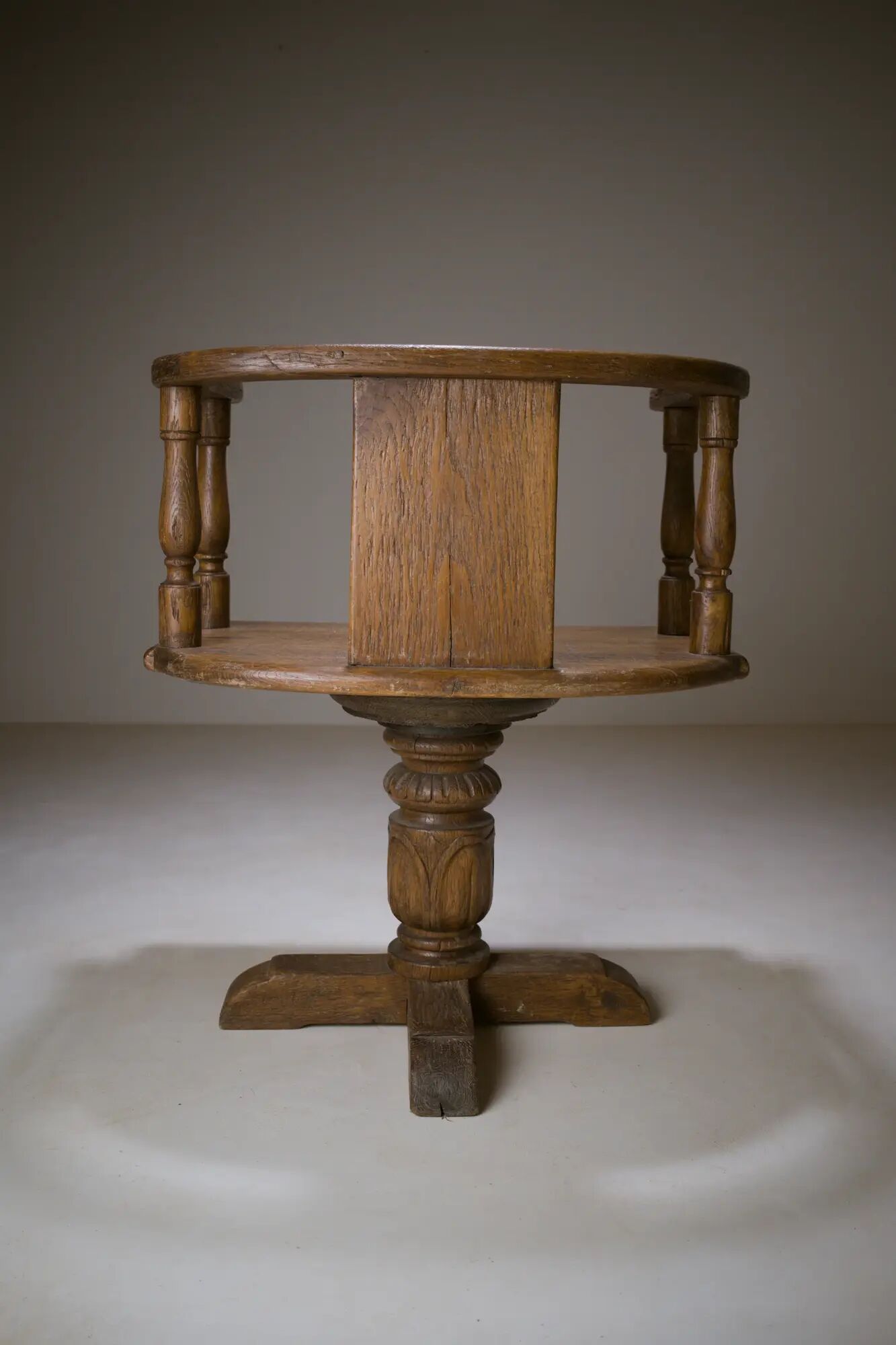 Swivel armchair in carved oak with ball bearings, early 20th century.