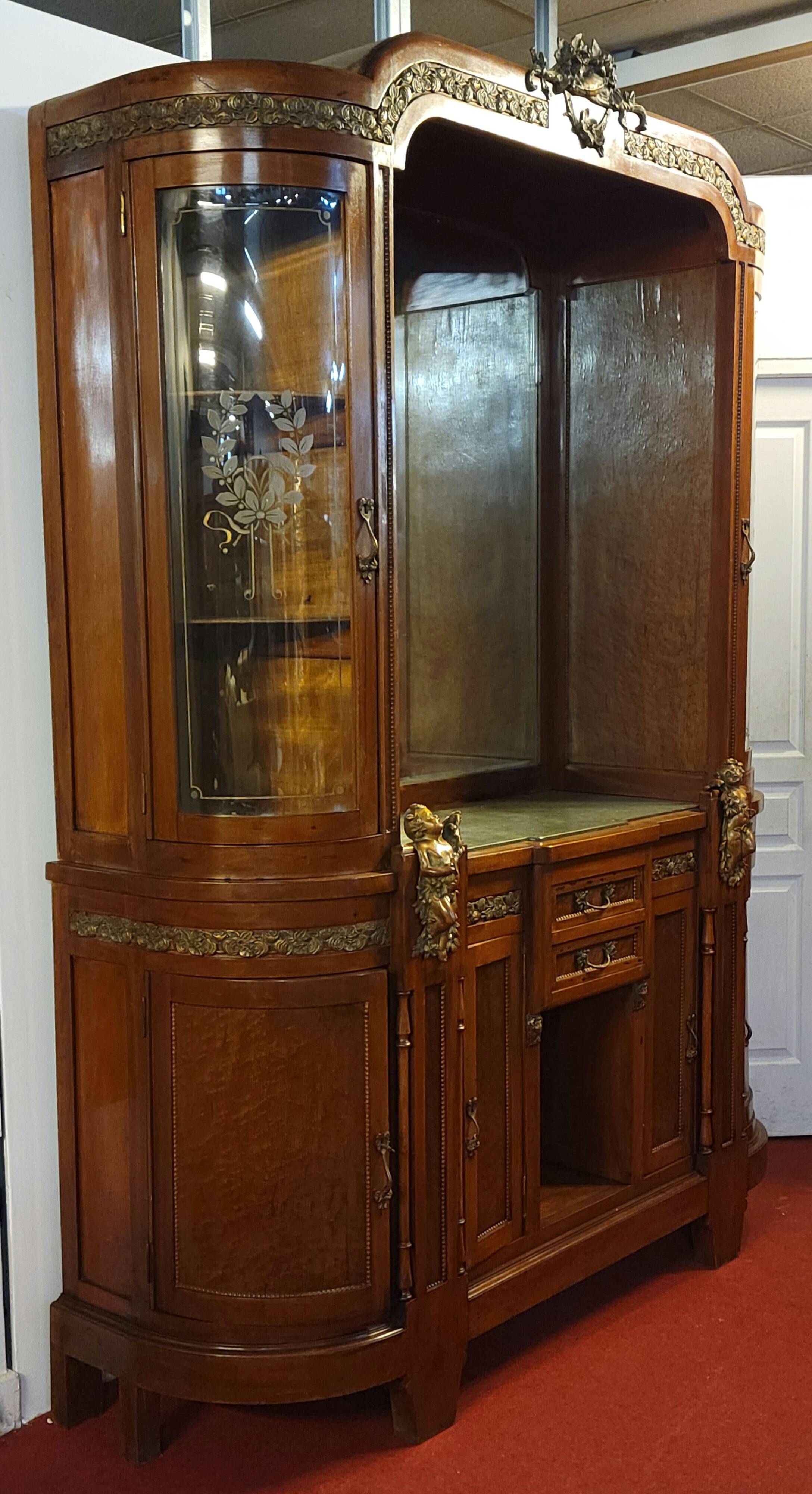Empire style half-moon shaped mahogany bookcase with putti