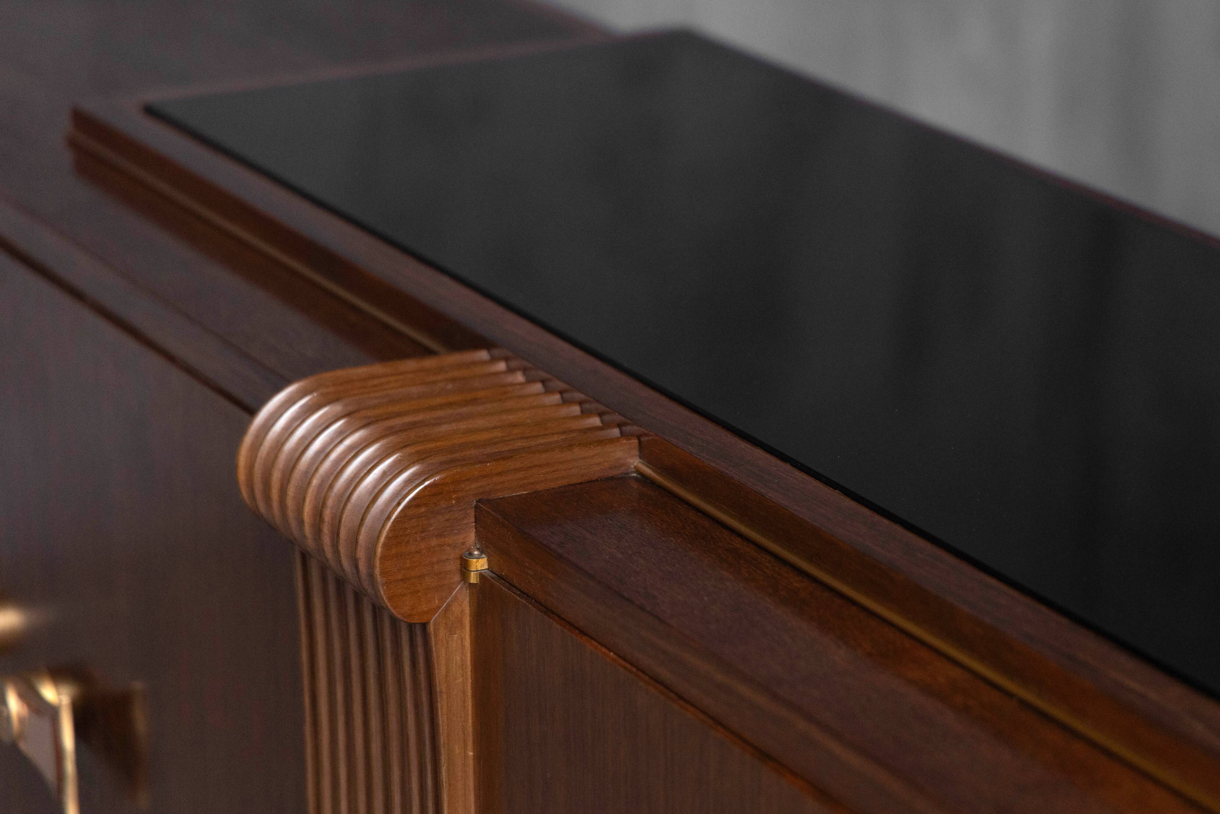 Art Deco walnut sideboard with brass details and sculptural base, France, 1930s