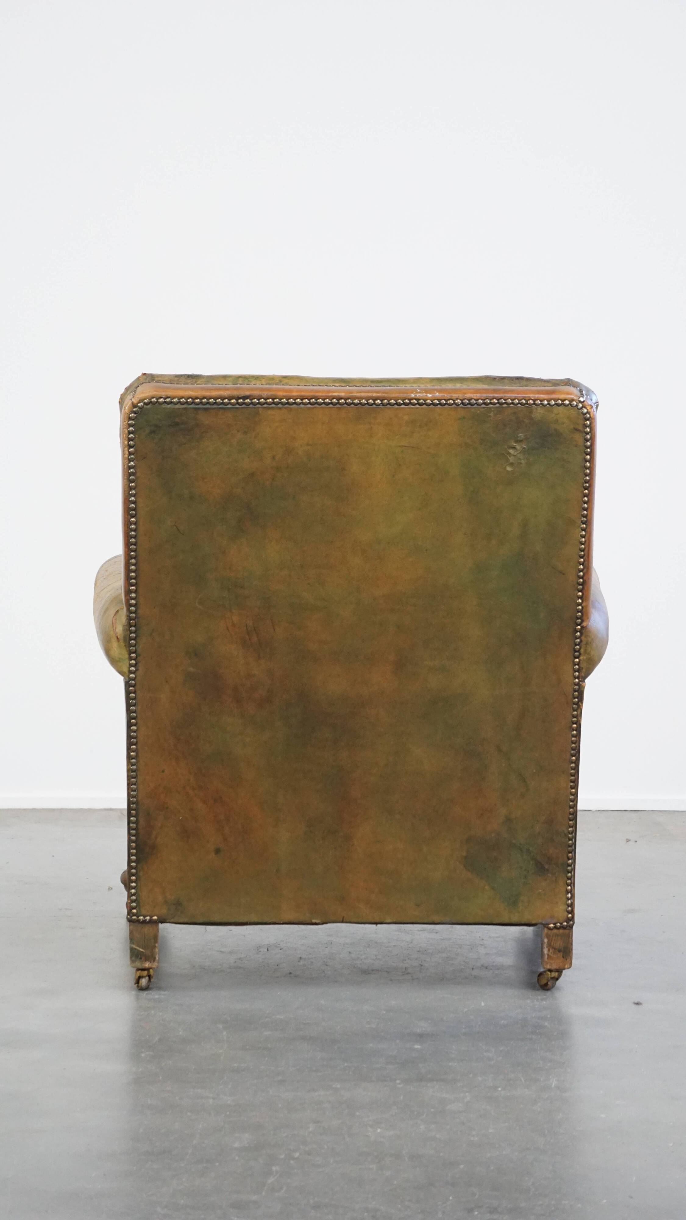 Green antique English cowhide leather armchair on wheels