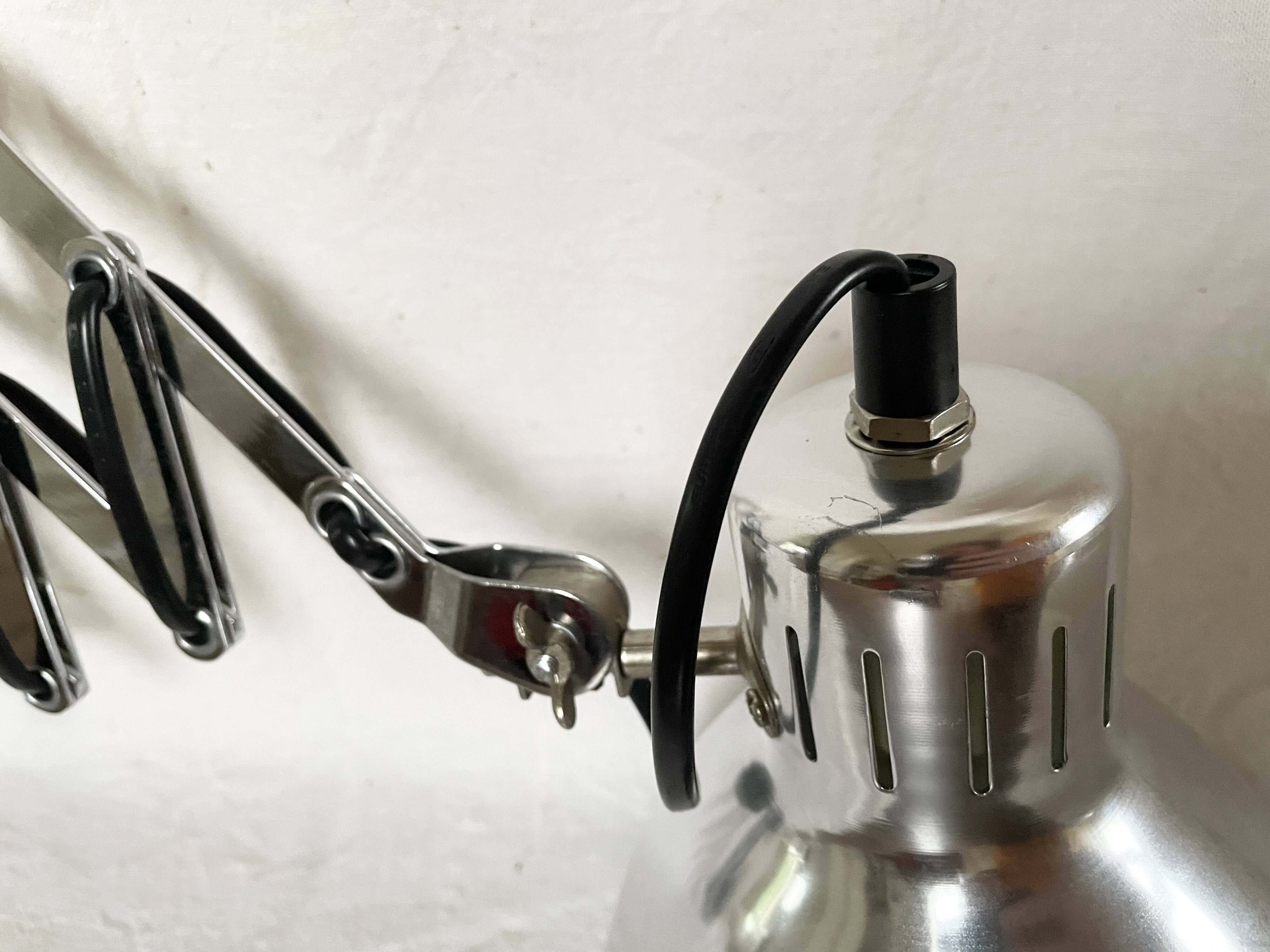 Vintage accordion wall light in chrome metal.