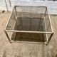 Square brass coffee table and smoked glasses