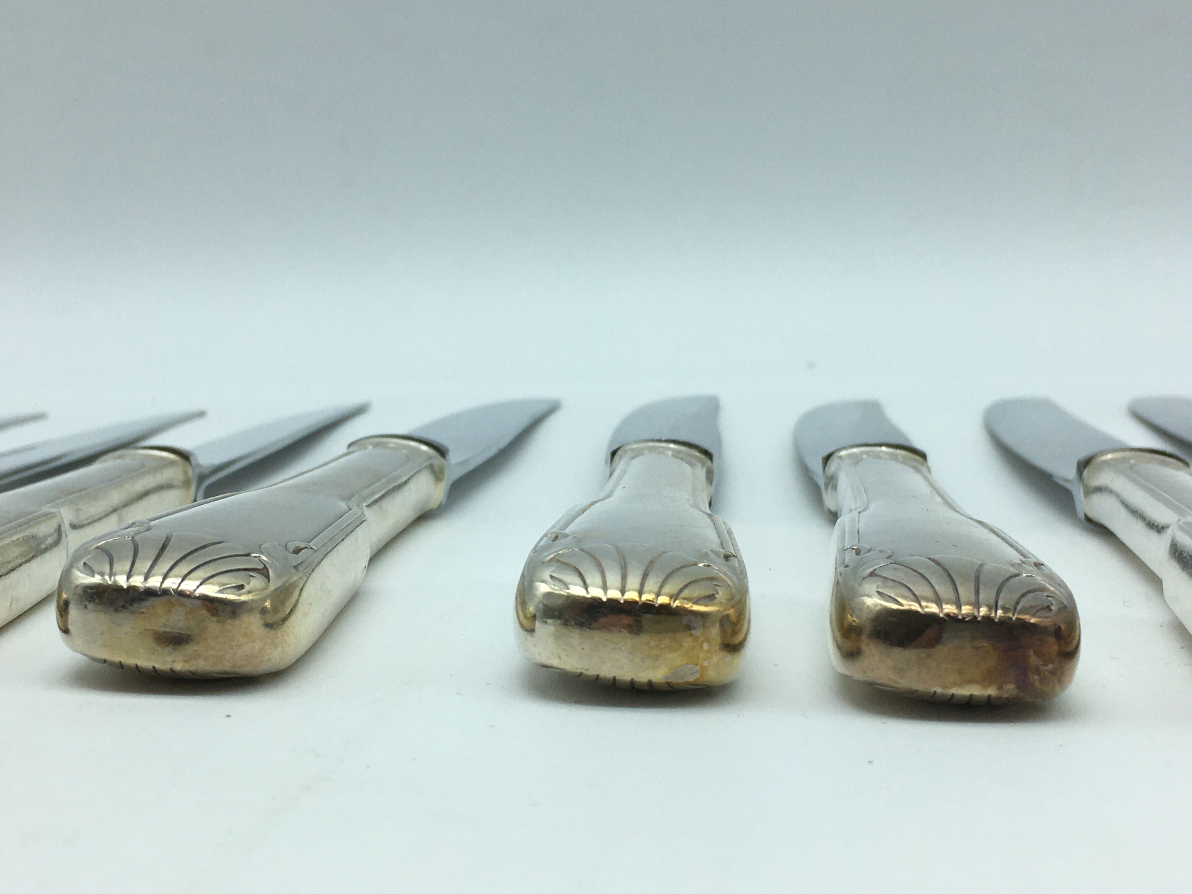 12 silver metal knives.