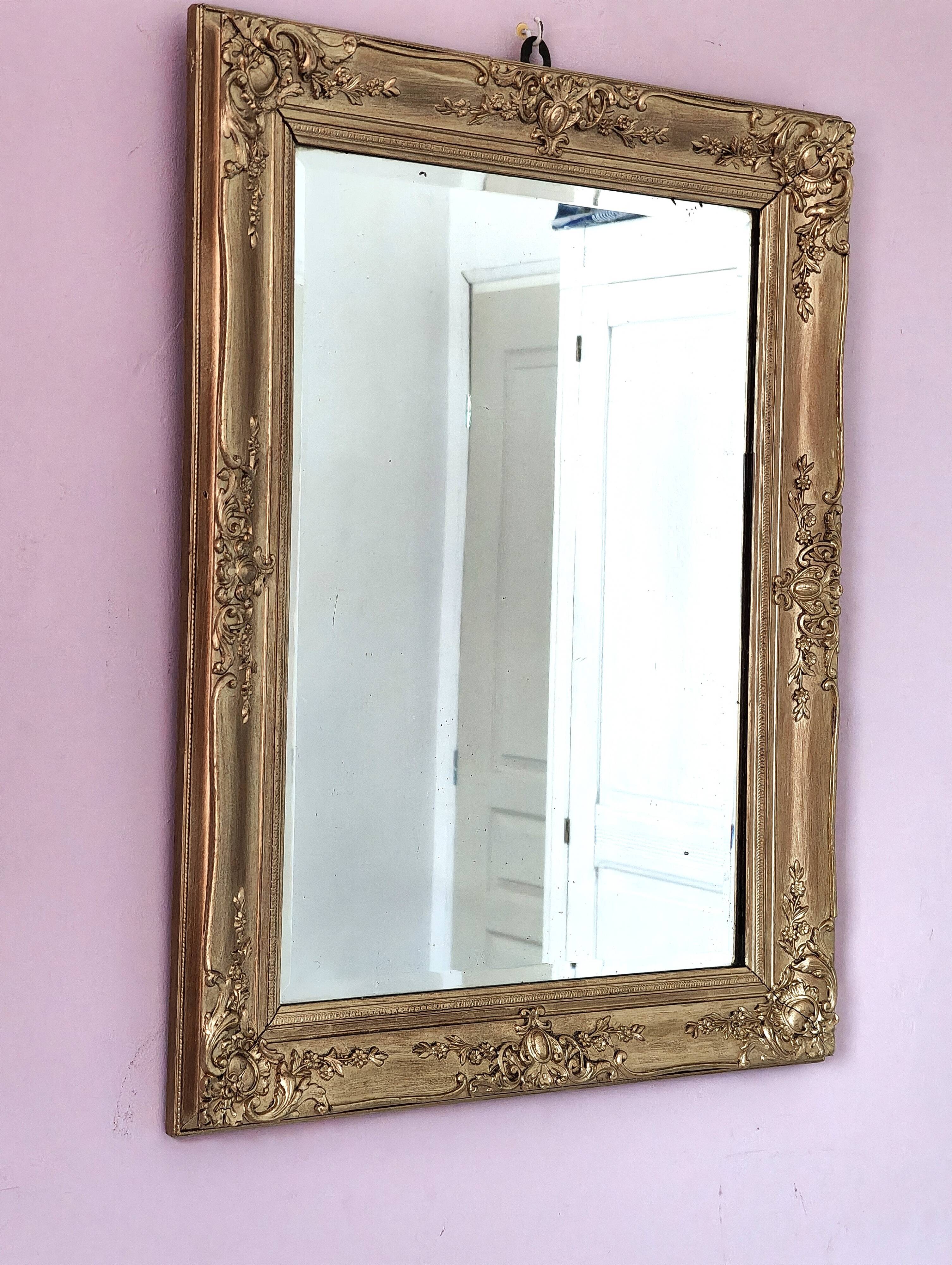 Richly carved antique gilded mirror