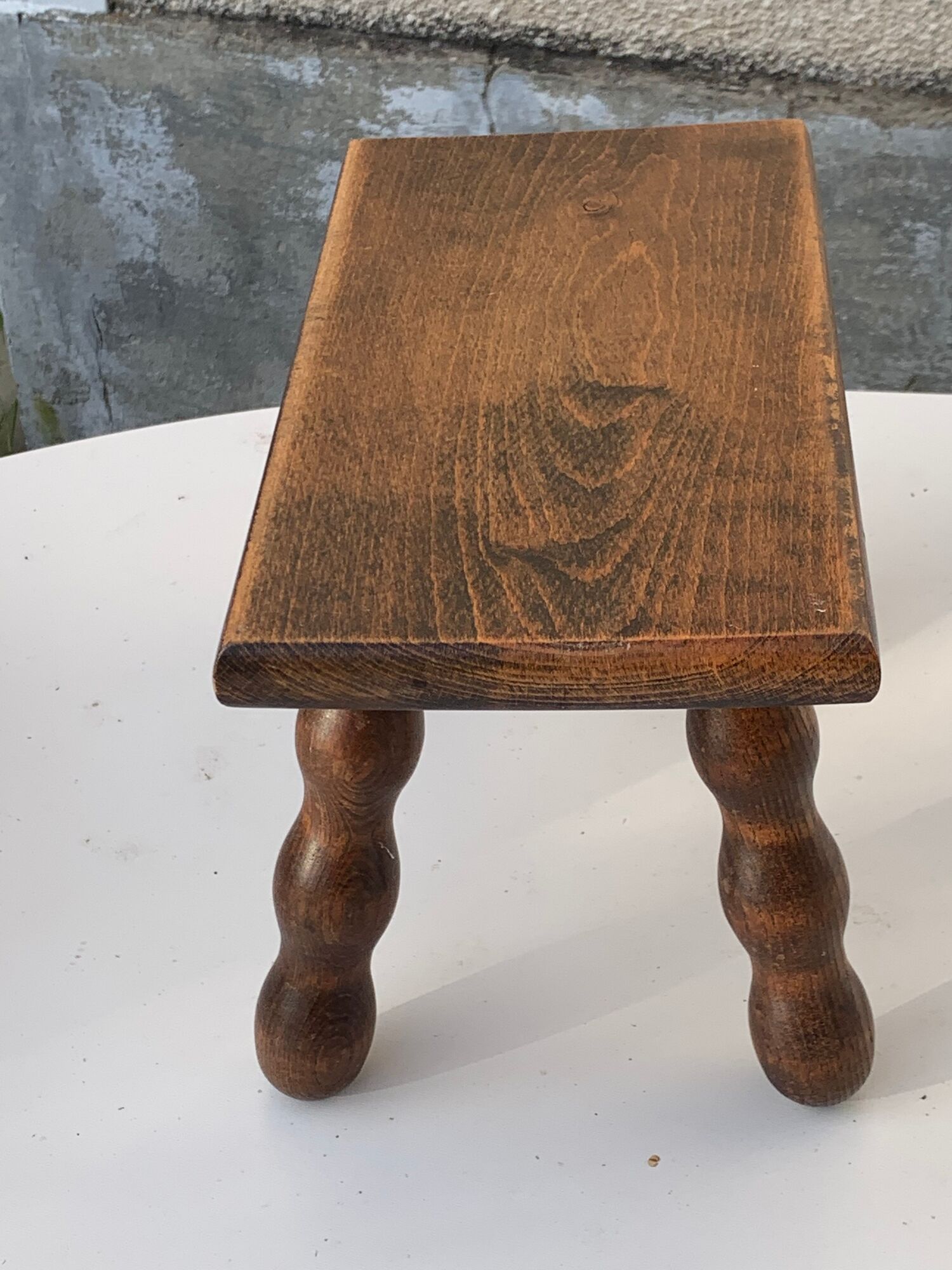 Footstool in varnished wood turns old