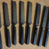 A set of 8 knives with black wooden handles