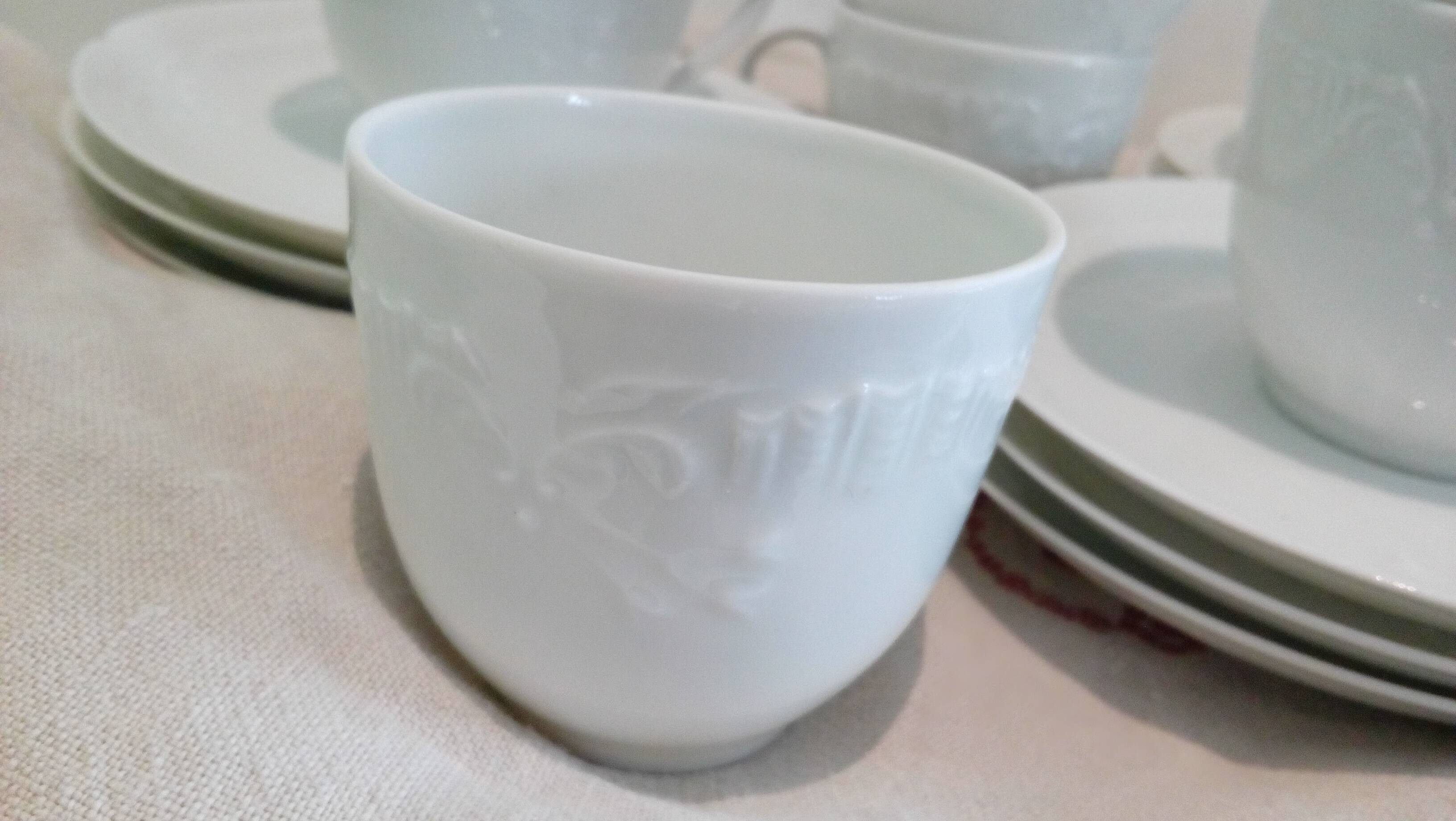 Set of 9 white porcelain coffee cups
