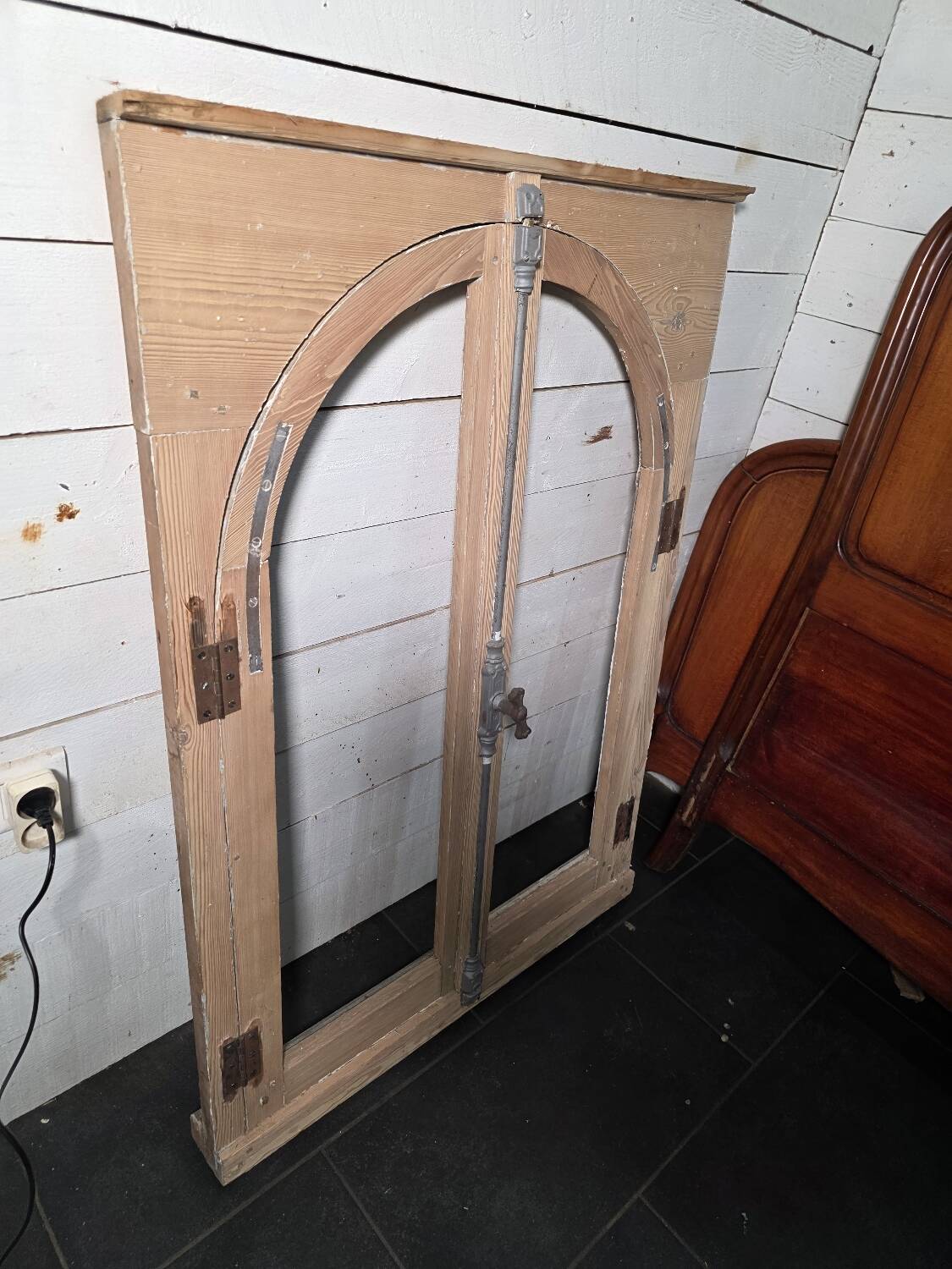Old arched window made of fir wood