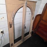 Old arched window made of fir wood