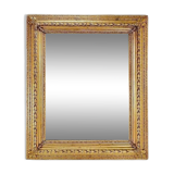 Large gilded wood and stucco mirror with foliage