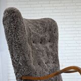 1960s, reupholstered Danish armchair, with stool, genuine sheepskin.