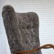 1960s, reupholstered Danish armchair, with stool, genuine sheepskin.