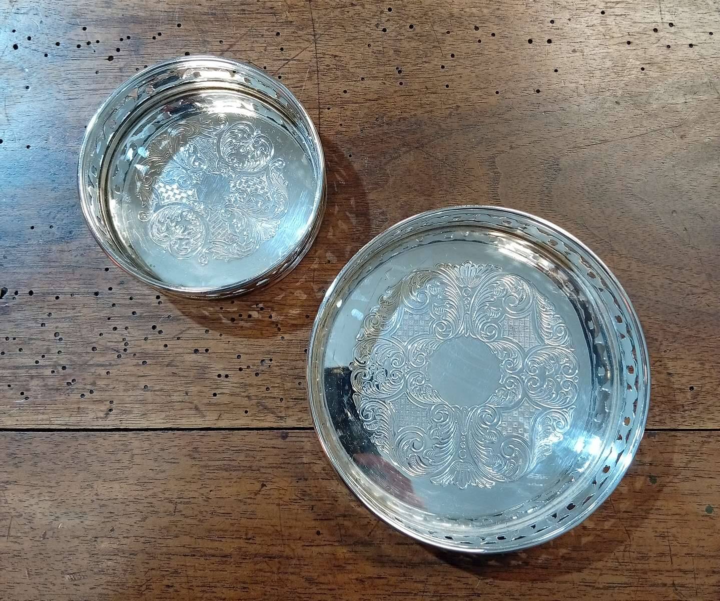 A pair of silver-plated bottle coasters for 75cl and 25cl.