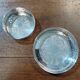 A pair of silver-plated bottle coasters for 75cl and 25cl.
