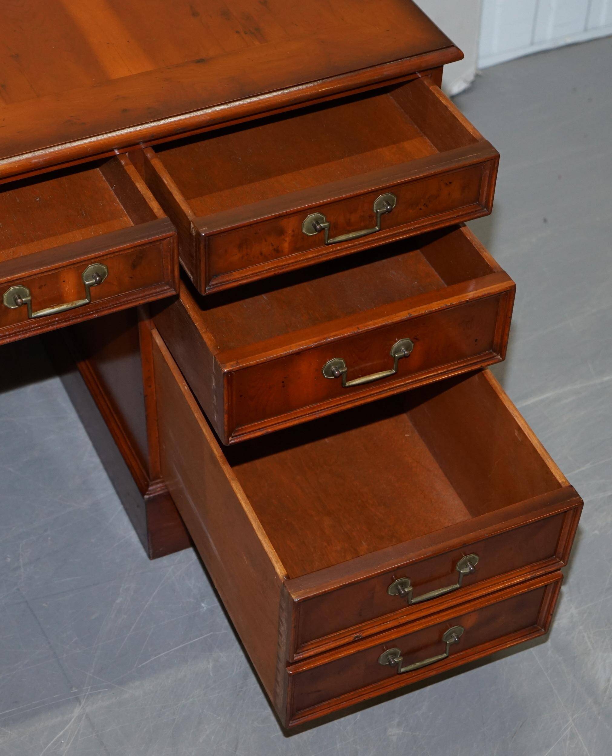 Partner desk with double pedestal in burr yew wood with decorated top.
