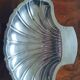 Butter dish, small bowl or shell-shaped trinket dish in silver-plated metal.
