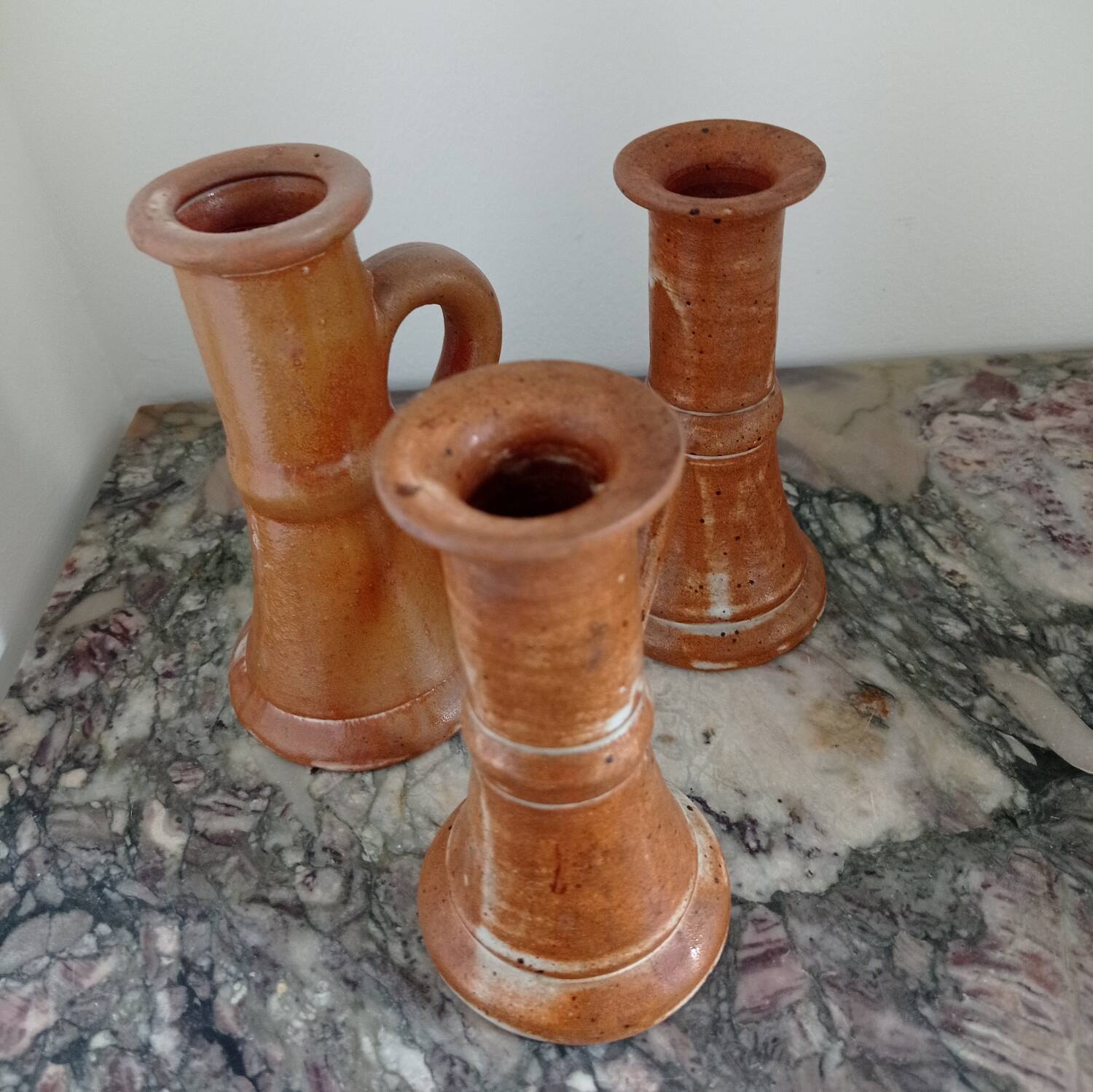 Enamelled stoneware candle holders