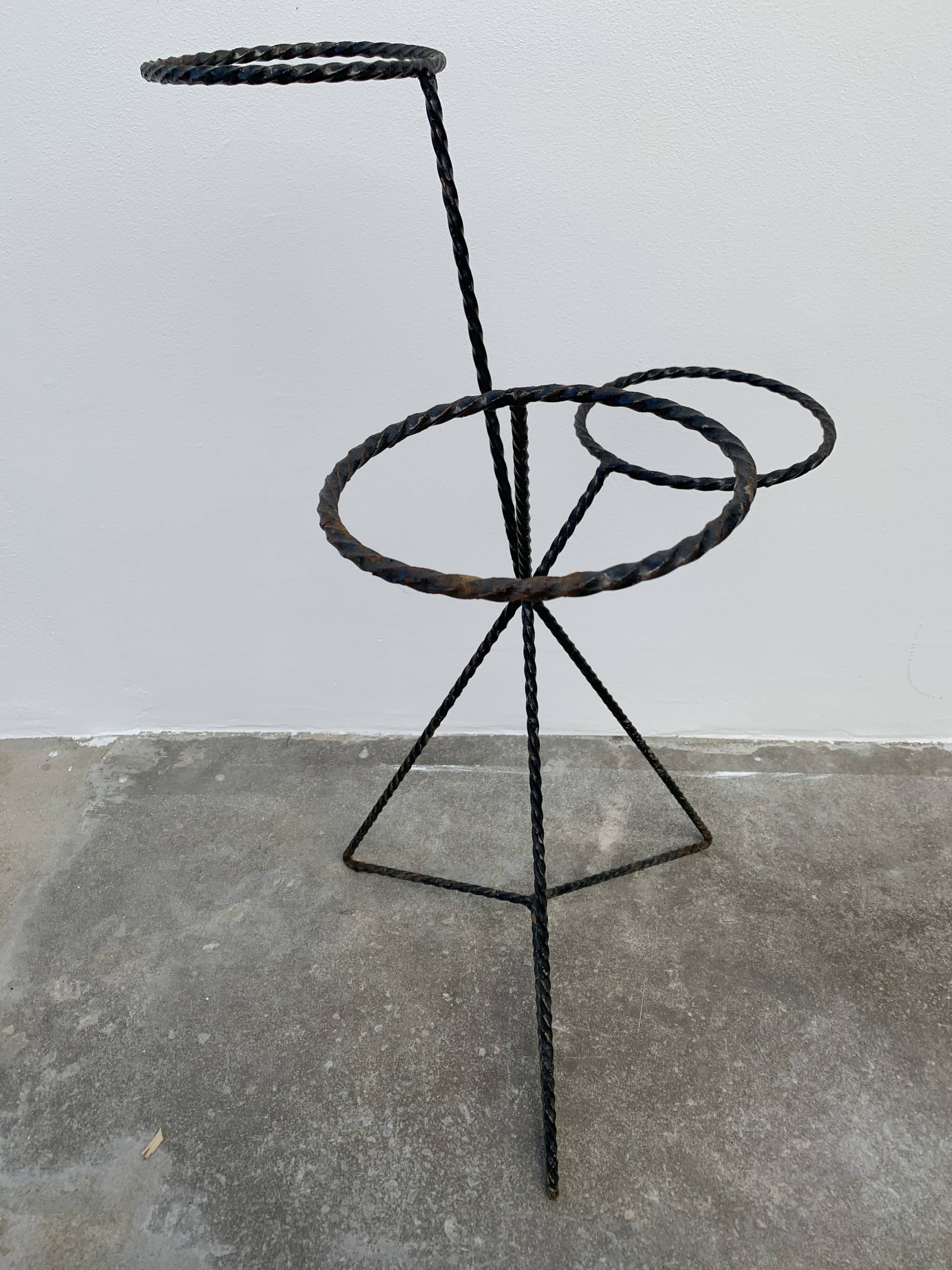 Black metal tripod plant holder