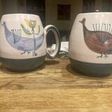 Set of two ceramic mugs signed Yvon ROY