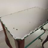 Glass art deco mirror beside table