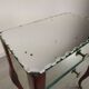Glass art deco mirror beside table