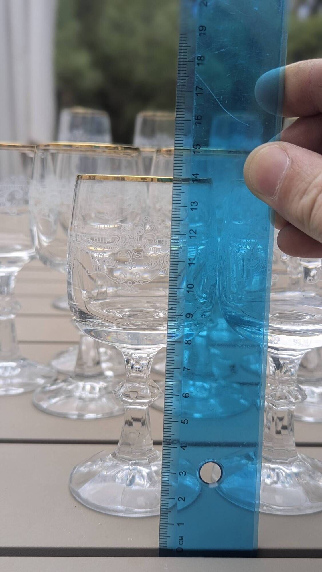 Set of 15 engraved crystal glasses with a gold rim.