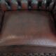 Classic cowhide Chesterfield sofa in English style with red/brown colours