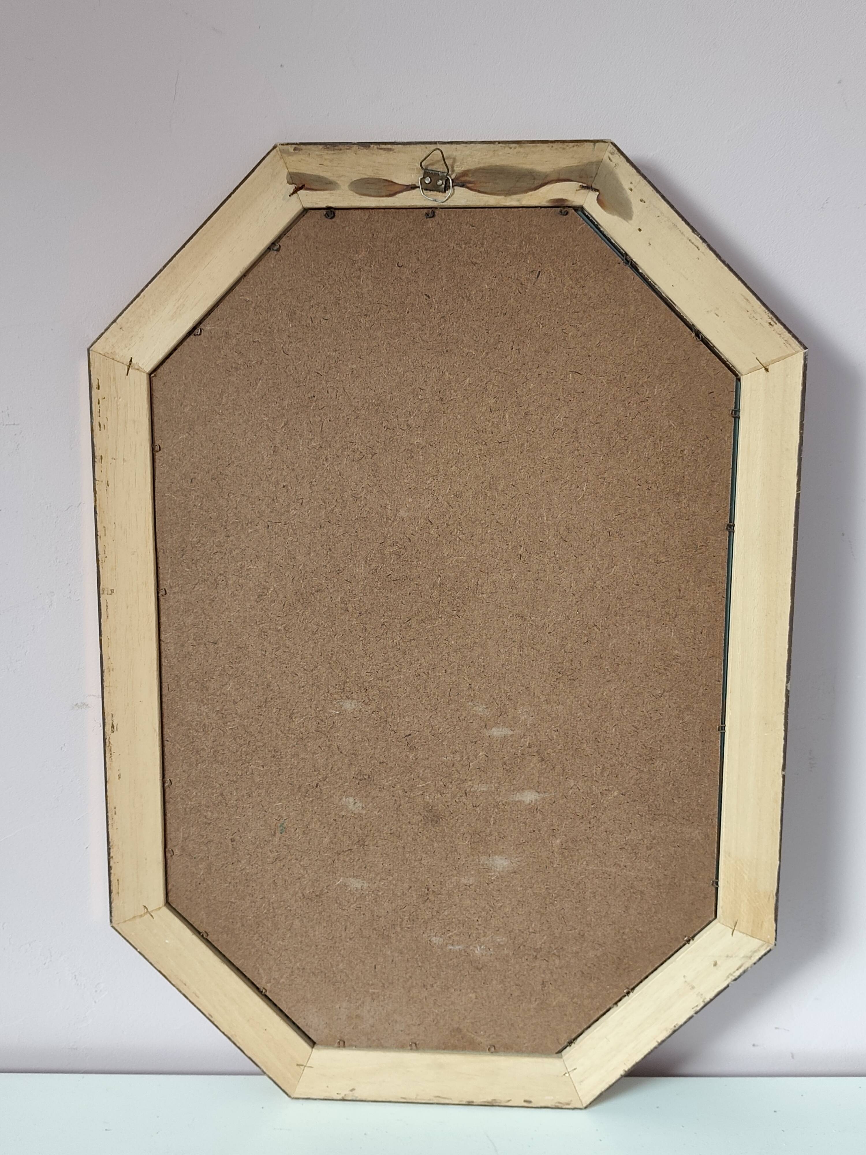 Golden octagonal mirror with bevelled glass from the 1970s.